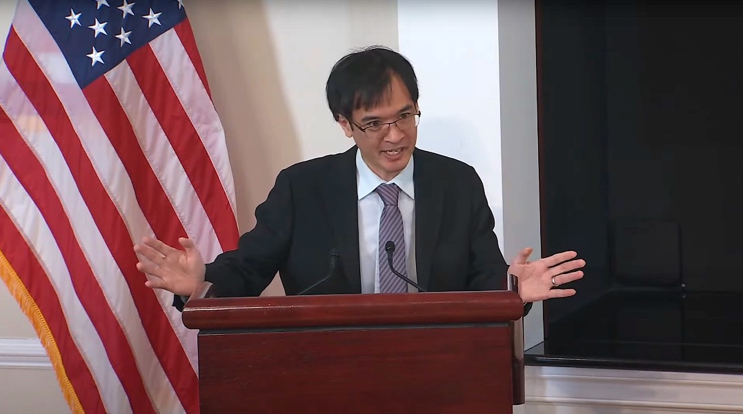 Terence Tao speaks at a podium in the White House.
